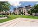 Modern building with brick and siding, balconies and beautiful landscaping at 15 W Executive Dr # 104, Carmel, IN 46032