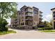 Multi-story condo building with balconies and convenient parking garage at 15 W Executive Dr # 104, Carmel, IN 46032