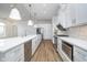 Spacious kitchen featuring stainless steel appliances, an island, plenty of cabinet space, and modern lighting at 15 W Executive Dr # 104, Carmel, IN 46032