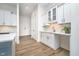 Bright kitchen with white cabinetry, stainless steel appliances, mosaic backsplash, and modern countertops at 15 W Executive Dr # 104, Carmel, IN 46032