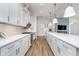 Modern kitchen with stainless appliances, white counters, and modern island with a long view of the cooking area at 15 W Executive Dr # 104, Carmel, IN 46032