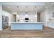 Spacious kitchen boasts a large center island, stainless steel appliances, and white cabinets with a view to living area at 15 W Executive Dr # 104, Carmel, IN 46032