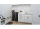 Utility room with vinyl floors, white walls, and a utility sink at 15 W Executive Dr # 104, Carmel, IN 46032