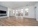 Living room with sliding glass doors to balcony and a shiplap accent wall with fireplace at 15 W Executive Dr # 104, Carmel, IN 46032