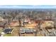 An aerial view of homes, driveways, and a large number of bare trees in the neighborhood at 1852 W 62Nd St, Indianapolis, IN 46260