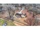 Aerial view of a single Gathering house with a large yard, shed, and surrounding bare trees at 1852 W 62Nd St, Indianapolis, IN 46260