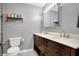 Bathroom featuring a toilet, vanity with double sinks, and storage for convenience at 1852 W 62Nd St, Indianapolis, IN 46260
