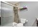 Bathroom includes a toilet, shower with glass doors, and a towel rack at 1852 W 62Nd St, Indianapolis, IN 46260