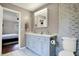 Beautiful bathroom with double vanity, tiled walls, and toilet, adjacent to connected bedroom at 1852 W 62Nd St, Indianapolis, IN 46260