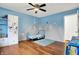 A cozy bedroom with a mountain mural, hardwood floors, and blue accents creates a playful space at 1852 W 62Nd St, Indianapolis, IN 46260