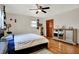 Bedroom with hardwood floors, one window, a ceiling fan and a comfortable bed and matching furniture at 1852 W 62Nd St, Indianapolis, IN 46260