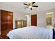 Bedroom with hardwood floors, one window, a ceiling fan and a comfortable bed and matching furniture at 1852 W 62Nd St, Indianapolis, IN 46260