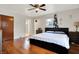 Bedroom with hardwood floors, two windows, a ceiling fan and a comfortable bed and matching furniture at 1852 W 62Nd St, Indianapolis, IN 46260