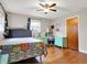 Bright bedroom with hardwood floors, one window, ceiling fan and comfortable bed with matching furniture at 1852 W 62Nd St, Indianapolis, IN 46260