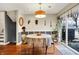 Dining room featuring hardwood floors, a gray accent wall, and large sliding glass doors at 1852 W 62Nd St, Indianapolis, IN 46260