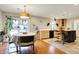 Bright dining area with outdoor access, hardwood floors, and vintage lighting at 1852 W 62Nd St, Indianapolis, IN 46260