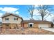 Charming split-level home with brick and siding exterior, attached garage, and solar panels on the roof at 1852 W 62Nd St, Indianapolis, IN 46260