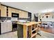 Updated kitchen with custom island, stainless steel appliances, and subway tile backsplash at 1852 W 62Nd St, Indianapolis, IN 46260
