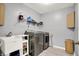 Modern laundry room with stainless steel washer and dryer and open shelving at 1852 W 62Nd St, Indianapolis, IN 46260
