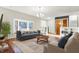 Bright living room with large bay window, hardwood floors, modern furniture, and decorative shelving at 1852 W 62Nd St, Indianapolis, IN 46260