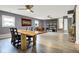 Open floorplan featuring sleek floors and a unique wood table perfect for entertaining at 1852 W 62Nd St, Indianapolis, IN 46260