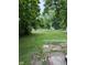 This property features a grassy backyard and partial fence at 2312 Fletcher St, Anderson, IN 46016