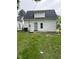 The backyard has a back door, concrete patio and green grass at 2312 Fletcher St, Anderson, IN 46016