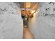 A narrow basement hallway showcases the foundation, utilities and potential for customization at 2312 Fletcher St, Anderson, IN 46016