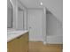 Bathroom with new wood-look flooring, modern vanity, and bright white tub at 2312 Fletcher St, Anderson, IN 46016