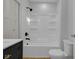 Updated bathroom with a shower and tub combo and modern hardware at 2312 Fletcher St, Anderson, IN 46016