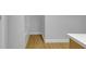Bathroom with wood-look flooring, bright white trim and light gray walls at 2312 Fletcher St, Anderson, IN 46016