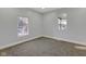Bright bedroom with windows, fresh paint, and new carpet flooring at 2312 Fletcher St, Anderson, IN 46016