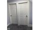 This space features two closets with white six panel doors and neutral carpet at 2312 Fletcher St, Anderson, IN 46016
