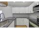 Well-lit kitchen with stainless steel appliances, white cabinets, subway tile backsplash, and granite countertops at 2312 Fletcher St, Anderson, IN 46016