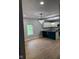 Open kitchen and dining area with modern lighting and hardwood floors at 2312 Fletcher St, Anderson, IN 46016