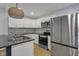 Open kitchen featuring white cabinets and stainless steel appliances at 2312 Fletcher St, Anderson, IN 46016