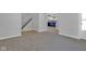 Inviting living room space showcasing stairs and an adjacent kitchen area at 2312 Fletcher St, Anderson, IN 46016