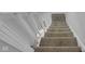 Carpeted staircase with white railing at 2312 Fletcher St, Anderson, IN 46016
