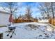 Large backyard with a wooden fence, storage shed, and an outdoor grilling area, covered in snow at 26 Highland Ave, Franklin, IN 46131