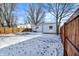 Backyard with a well-maintained fence surrounding a cozy single-Gathering home covered in snow at 26 Highland Ave, Franklin, IN 46131
