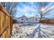 Spacious backyard featuring a high fence, storage shed, and ample room for outdoor activities, covered in snow at 26 Highland Ave, Franklin, IN 46131