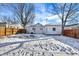 Snowy backyard featuring a well-maintained fence, an outdoor firepit, and a charming single-Gathering home at 26 Highland Ave, Franklin, IN 46131
