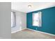 Bright bedroom featuring neutral gray walls, a pop of color, and two large windows at 26 Highland Ave, Franklin, IN 46131