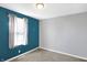 Bedroom featuring neutral gray walls, a pop of color, and a bright window at 26 Highland Ave, Franklin, IN 46131