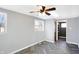 Well-lit bedroom with ceiling fan, herringbone floors, and closet space at 26 Highland Ave, Franklin, IN 46131