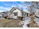 A cozy bungalow-style home with white siding, black shutters, and a well-manicured front yard at 26 Highland Ave, Franklin, IN 46131