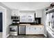Bright kitchen features white cabinets, black backsplash, wood countertops, and stainless steel appliances at 26 Highland Ave, Franklin, IN 46131