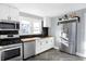 Well-equipped kitchen with stainless steel appliances, white cabinets, and stylish backsplash at 26 Highland Ave, Franklin, IN 46131