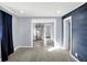Bright living room featuring modern gray walls, plush carpet, and views into kitchen at 26 Highland Ave, Franklin, IN 46131