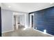 Bright living room featuring modern gray walls, plush carpet, and views into kitchen and hallway at 26 Highland Ave, Franklin, IN 46131